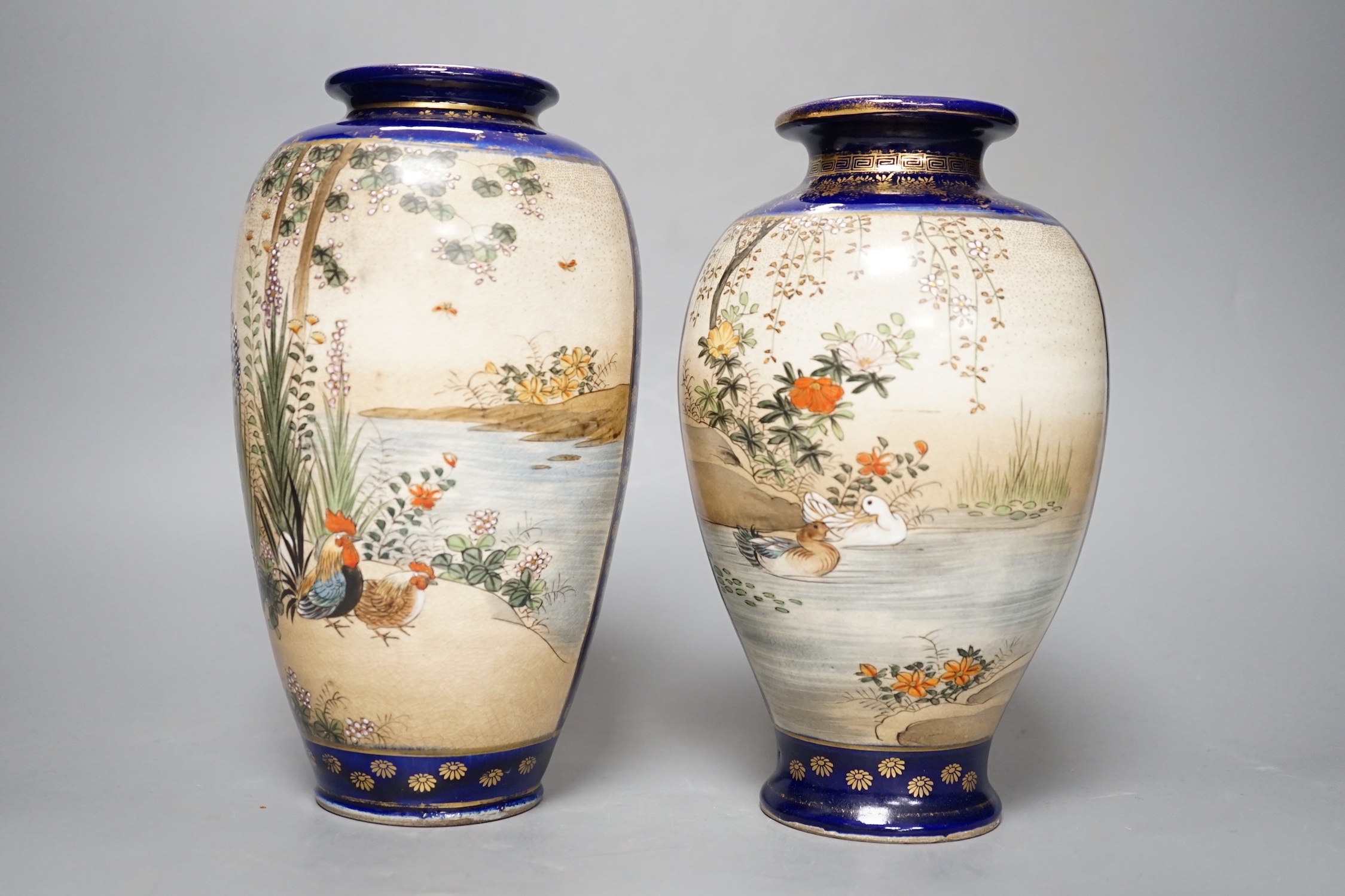 A pair of Japanese Satsuma pottery vases, one signed Kinkozan - 25cm high
